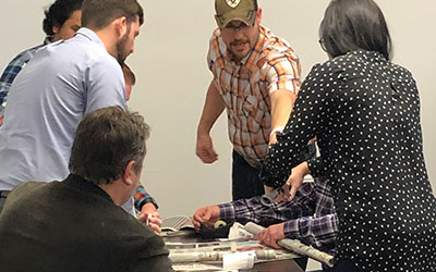 Data Projections' teammates gathered around a table