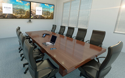 A large conference room setup by Data Projections with dual big screen monitors and AV control systems