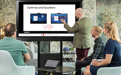 People taking notes on a Data Projections interactive display