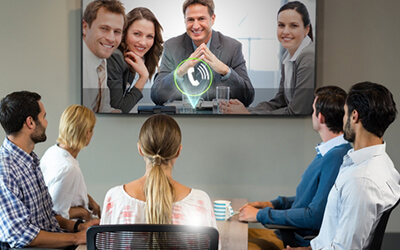 A boardroom on a video conference call, looking up at a big screen TV