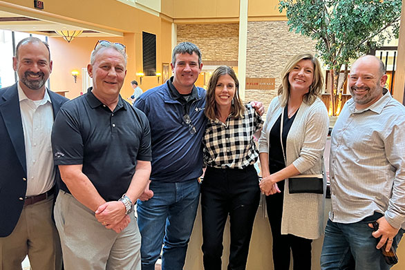 The Data Projections team smiling together in their main foyer