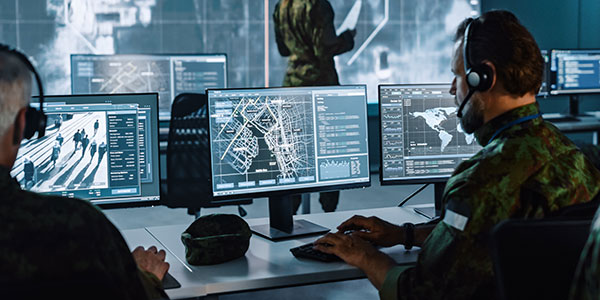 Military personnel working at computers state-of-the-art monitors from Data Projections