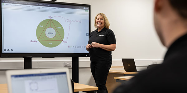 An AV integrator giving a presentation on a large interactive monitor