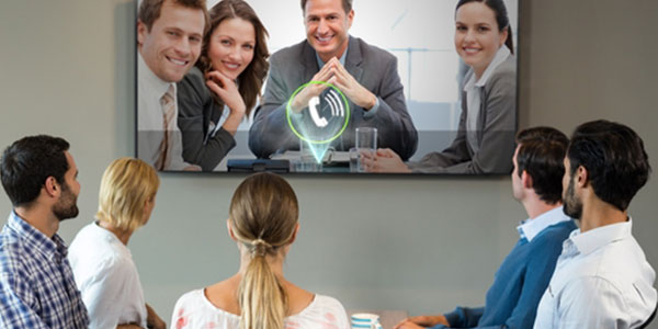 A boardroom on a video conference call, looking up at a big screen TV