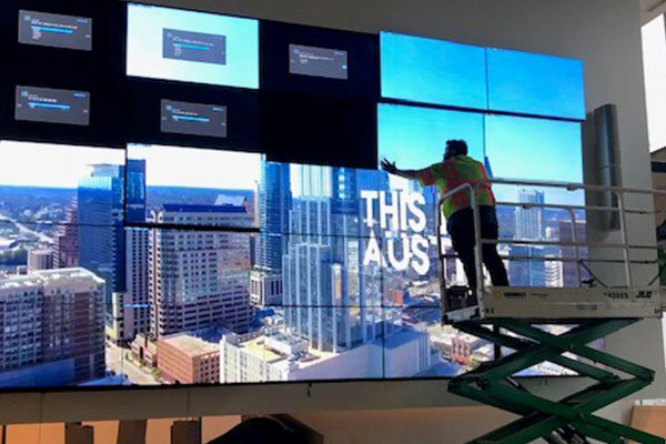 A Data Projections' crewman installing a new wall screens