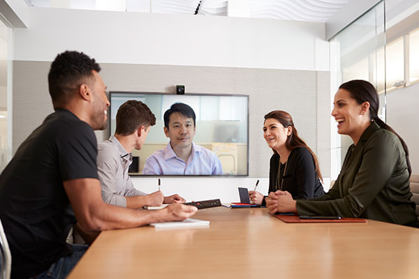 A team on a conference call with a client using Data Projections conference solutions