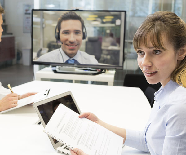 A business women and her team on a video conference call with a Data Projections specialist