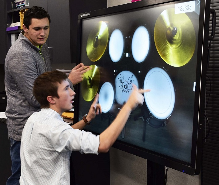 Rankin ISD students playing with virtual instruments on an interactive display from of Data Projections