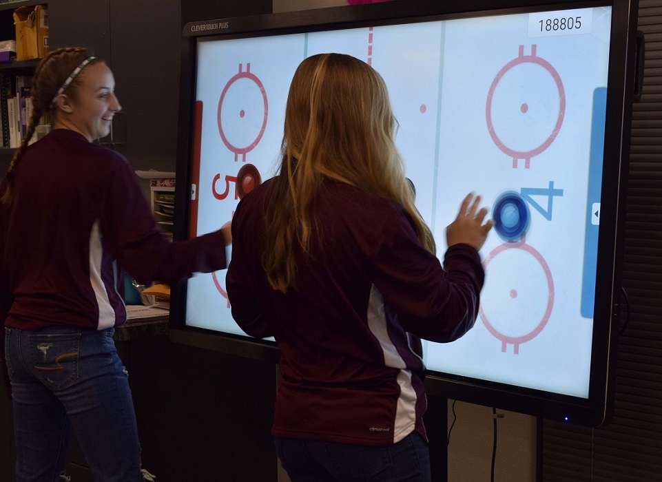 Rankin ISD students playing virtual air hockey on Data Projections interactive display
