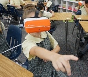 A female St. Mark student reaching out while enjoying the ClassVR standalone headset